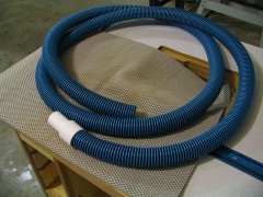 A section of cheap 1-1/4" pool vacuum hose, cut to roughly 12 feet in length.