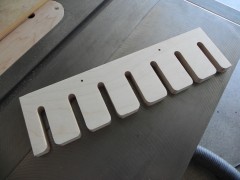 a 15-1/2" long rack segment with rounded openings.