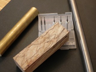 The raw materials, Spalted Hard Maple, o1 drill rod, 360 brass, & micro endmills.
